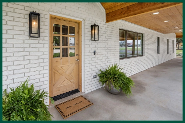 Large house with entryway accented by planters.